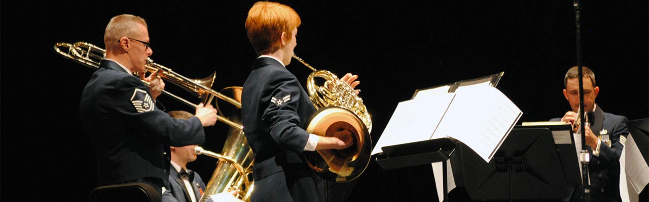 WCU Live! - brass quartet on stage. Quartet includes a trumpet player, french horn player, trombone player, and baritone player.
