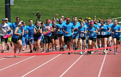 People running to the finish line of a track