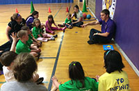 A student talking and teaching children
