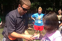 Student assisting a girl with an activity