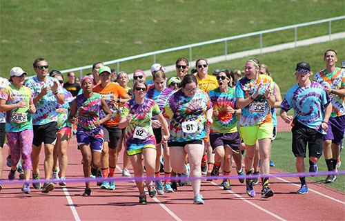 Students running to the finish line of a track