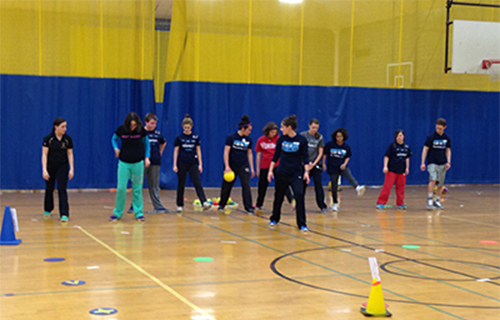 Student teaching children a game