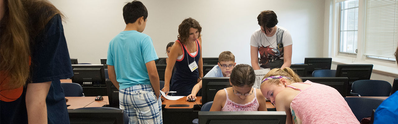 Teacher in computer classroom instructing