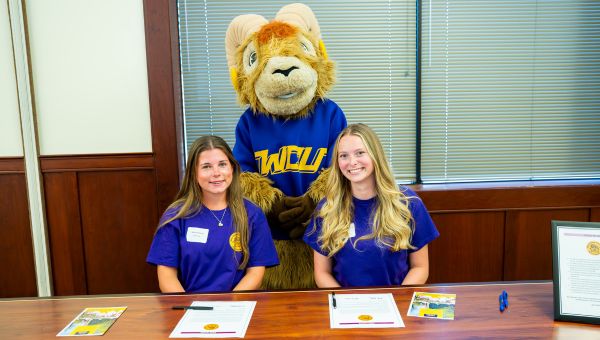 Rammy with two students on PRIZE signing day