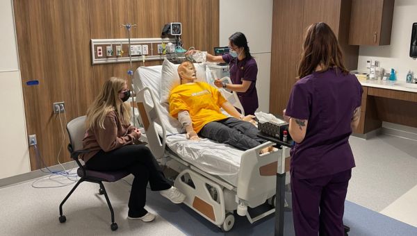 Nursing students working on mannequin in Immersive Learning Center