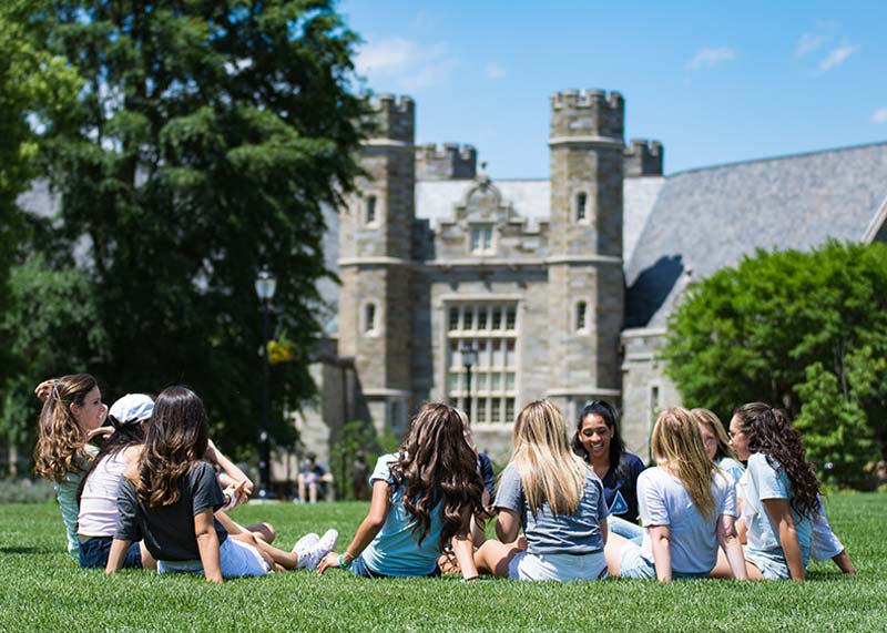 Group of sorority girls sitting in the quad in a circle