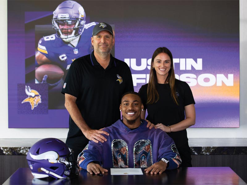 Emily Badis and Rob Brzezinski, Executive Vice President of Football Operations, were instrumental in negotiating Justin Jefferson's four-year, $140M contract extension in June 2024, making him one of the highest paid non-quarterbacks in the NFL. Photo courtesy of the Minnesota Vikings.