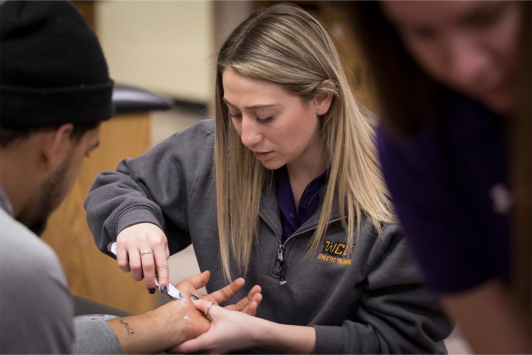 
						Athletic Training Student practicing on another student
					