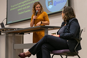 two women speaking on stage