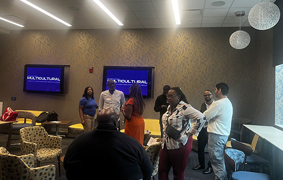 Photo of the room with people all conversing at mulitcultural event
